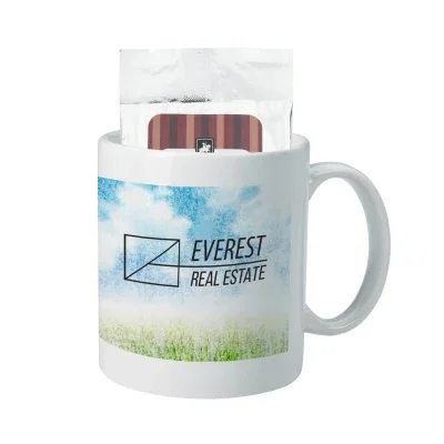 White 11 ounce ceramic mug paired with a hot cocoa packet