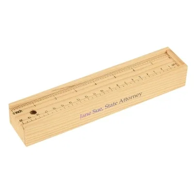 Twelve colored pencils stored in a wooden box with ruler markings