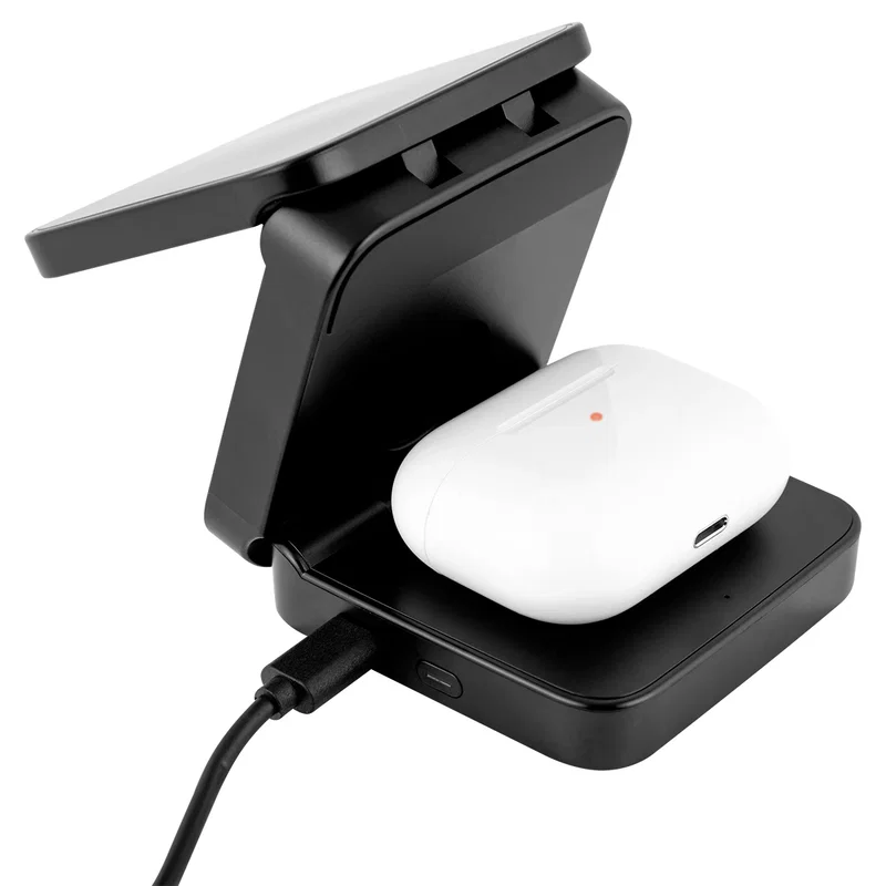 Charging dock resting on a desk beside a laptop
