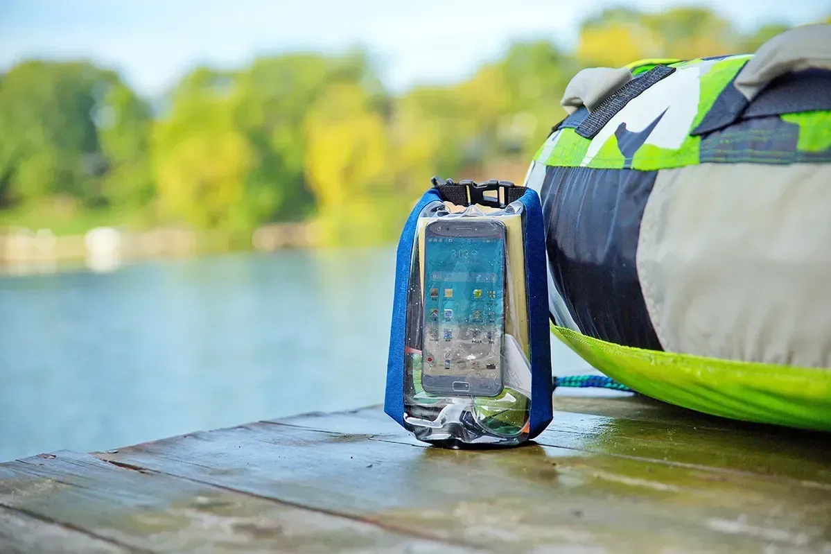 Branded 2-Liter Touch-Thru Phone Pocket Dry Bag shown rolled and sealed, promotional waterproof dry bag for gear