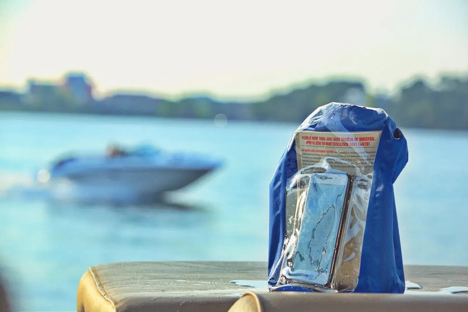 Branded 5L dry bag worn over the shoulder, kayaking lifestyle shot