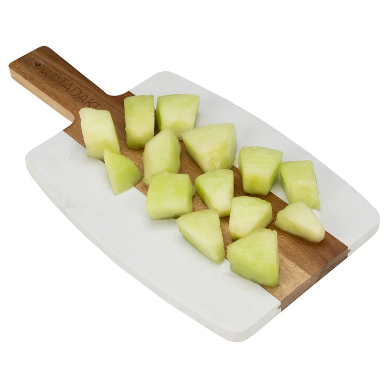 Acacia and marble cutting board, marble surface close-up