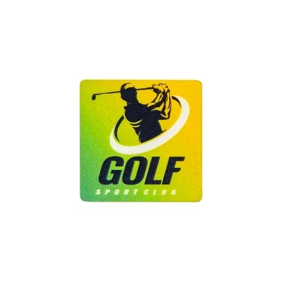 Square acrylic golf ball marker resting on a putting green