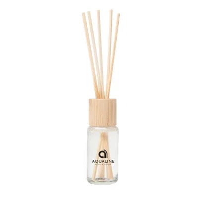 Natural reed diffuser bottle topped with a bamboo lid
