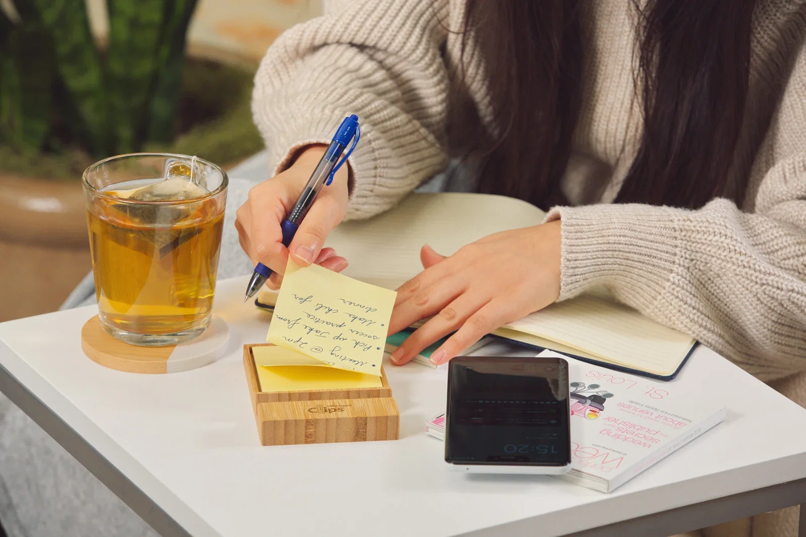 Bamboo Sticky Note Dispenser with Phone Holder in use