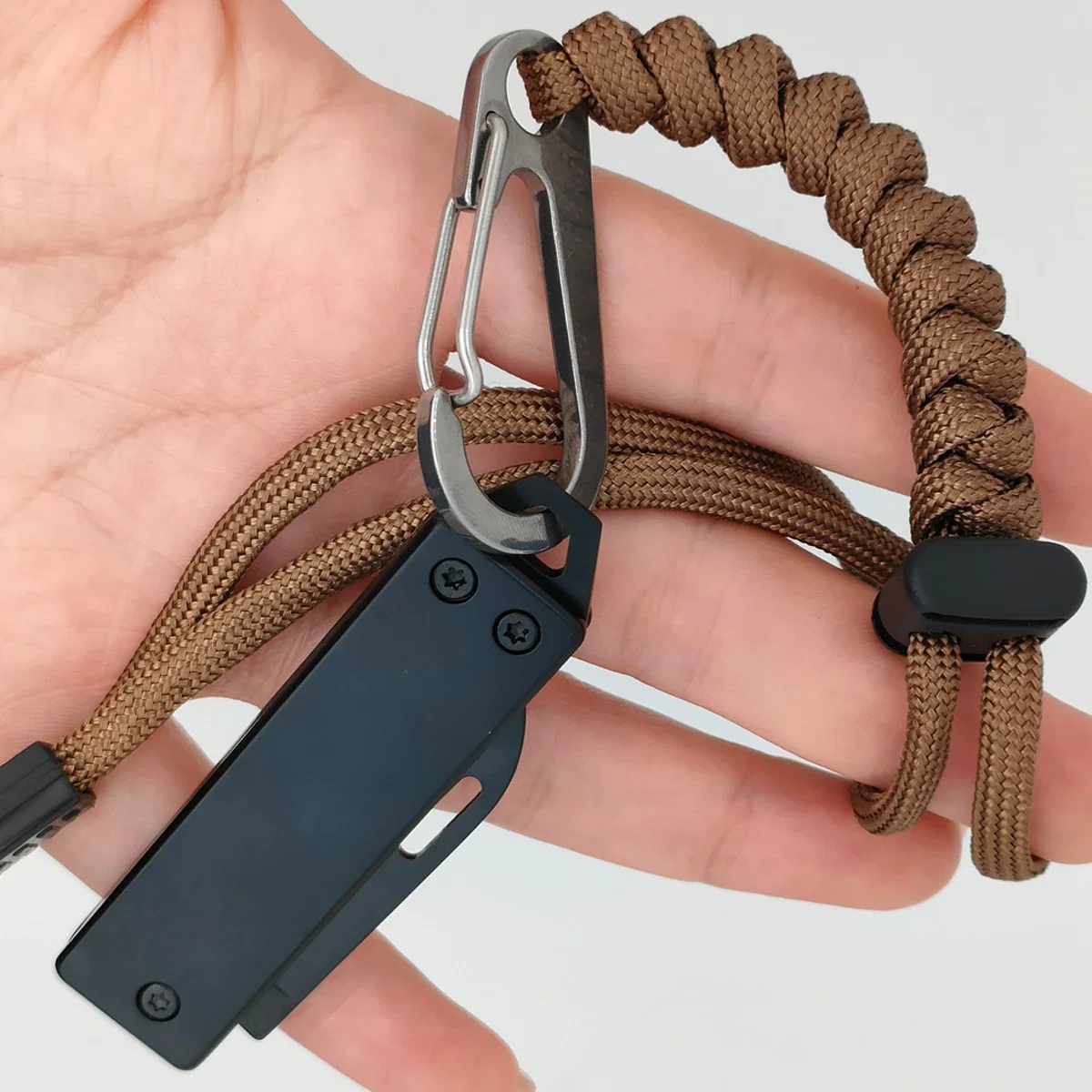 Custom Best Buddy Tools pocket knife clipped by a carabiner to a paracord keychain fob, held in hand