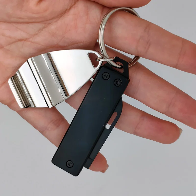 Branded Best Buddy Tools key chain pocket knife clipped to a keyring, in-use shot