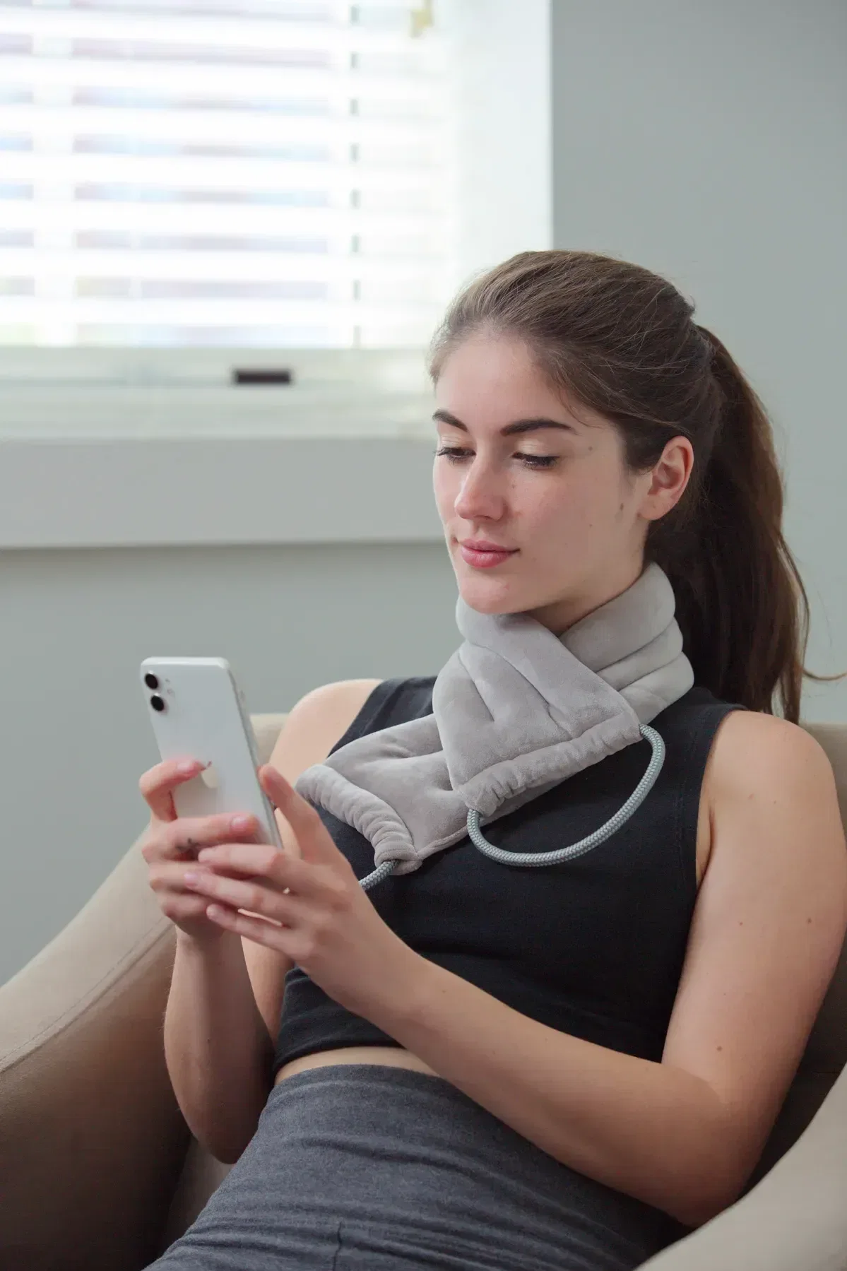 Branded BeWell neck pad draped over shoulders, lifestyle shot