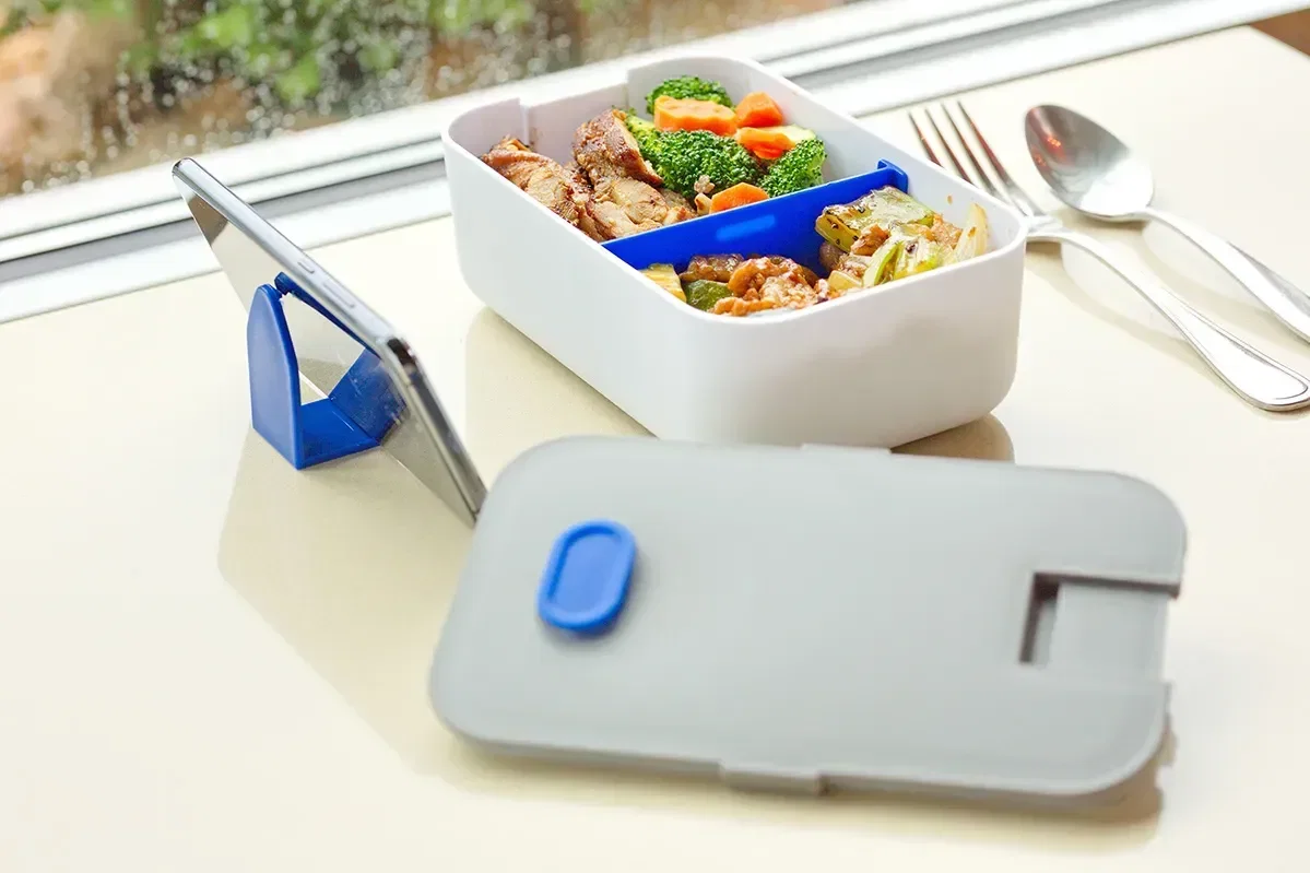 Promotional lunch box shown open with divided compartments