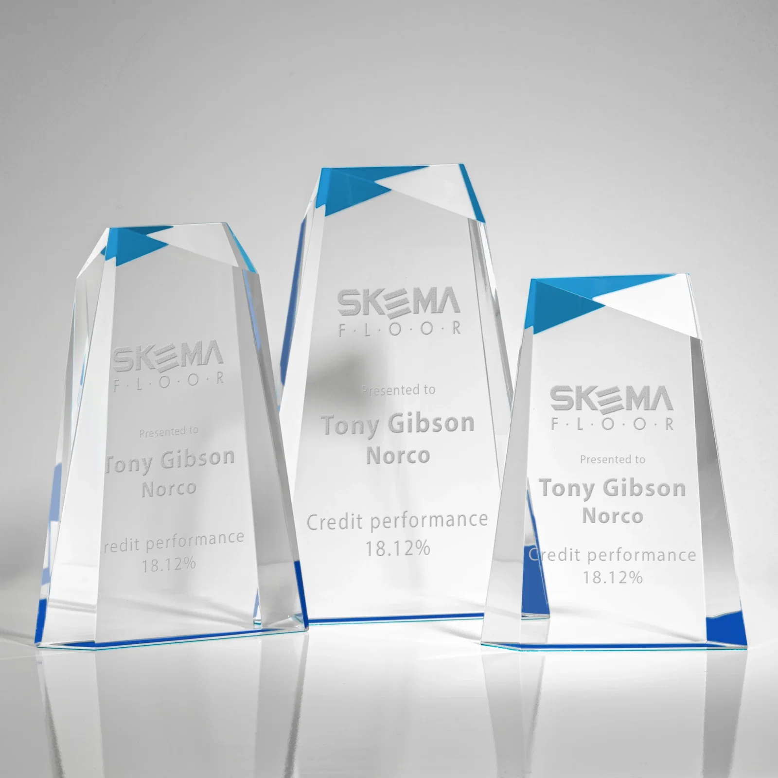 Custom Hand-Cut Facet Acrylic Tower Award on Mirrored Blue Base for employee recognition