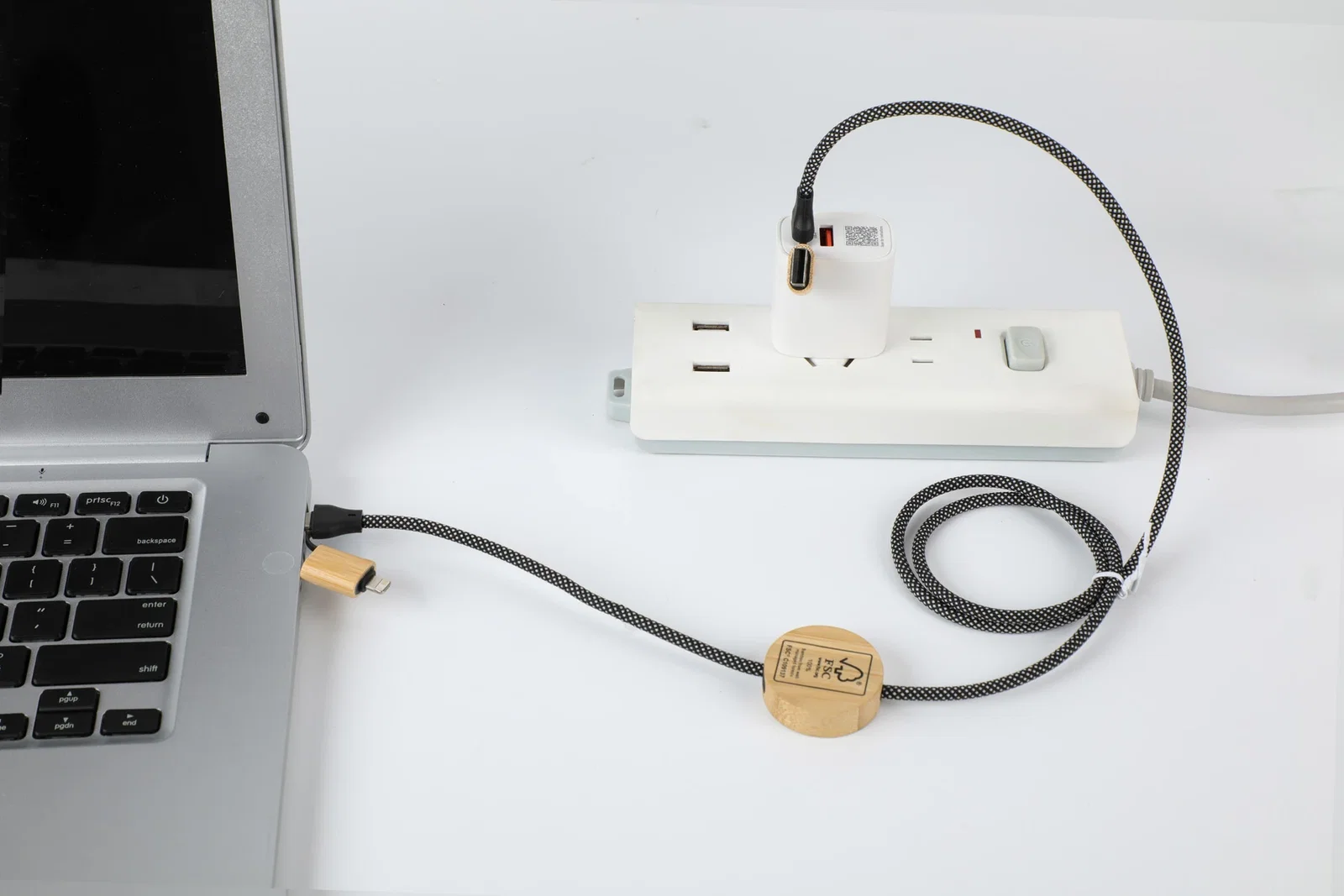 Bolt 4-in-1 Charging & Data Cable in use, charging a laptop with the branded 100W cable