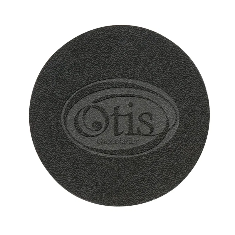 Underside of the coaster showing a uniformly flat black finish