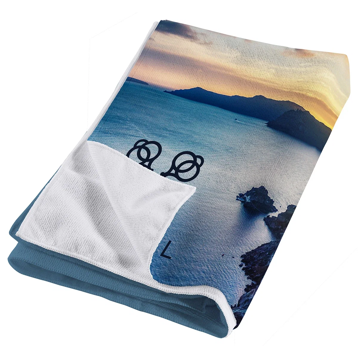 Breaker beach towel laid out on the sand, branded towel lifestyle shot