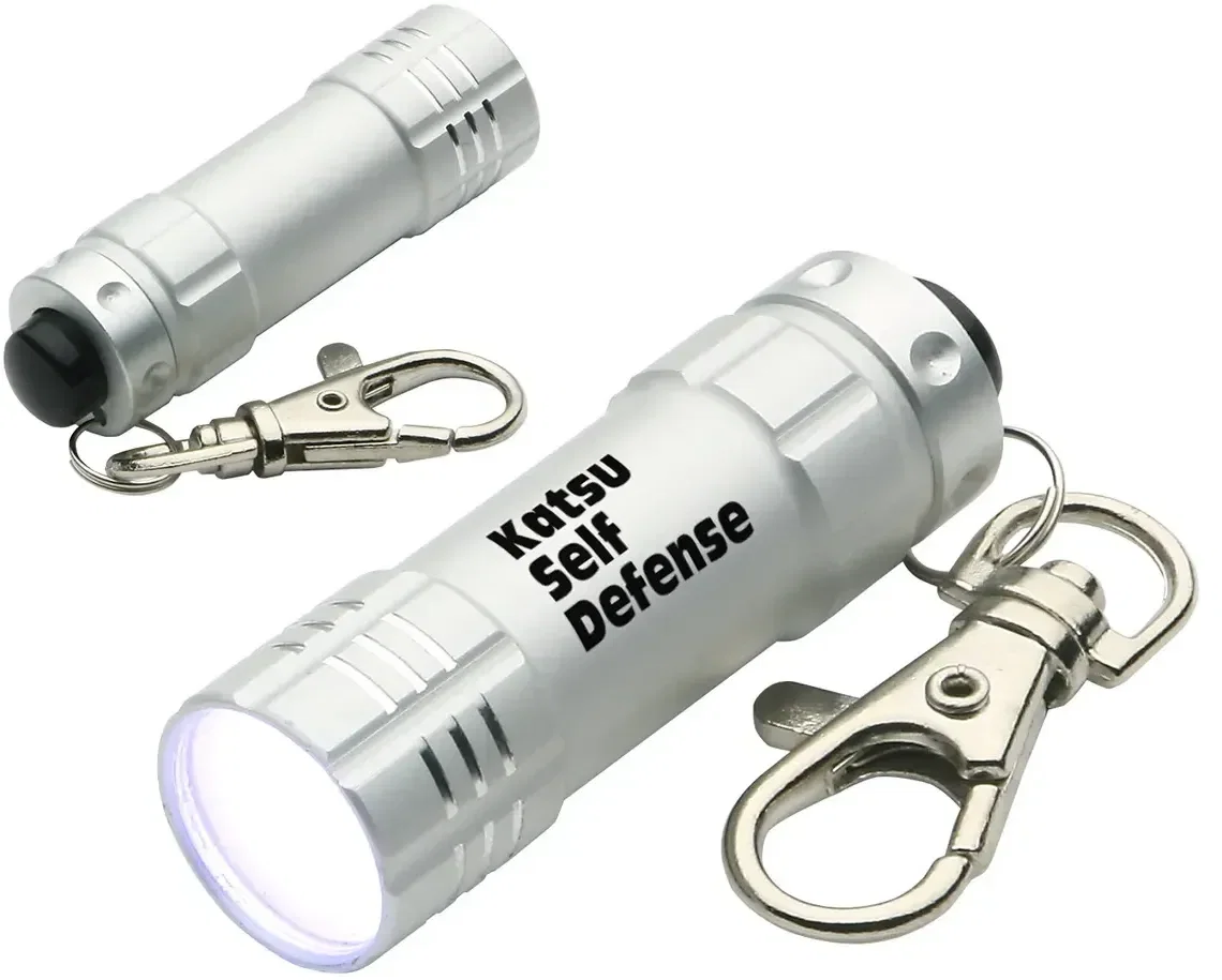 Branded Bright Shine keychain flashlight close-up of the rubber button and imprint area