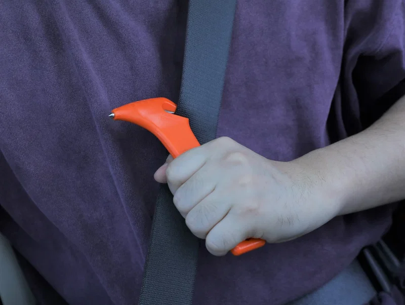 Side profile of the Car Escape Tool with Cutter, showing its compact keychain size