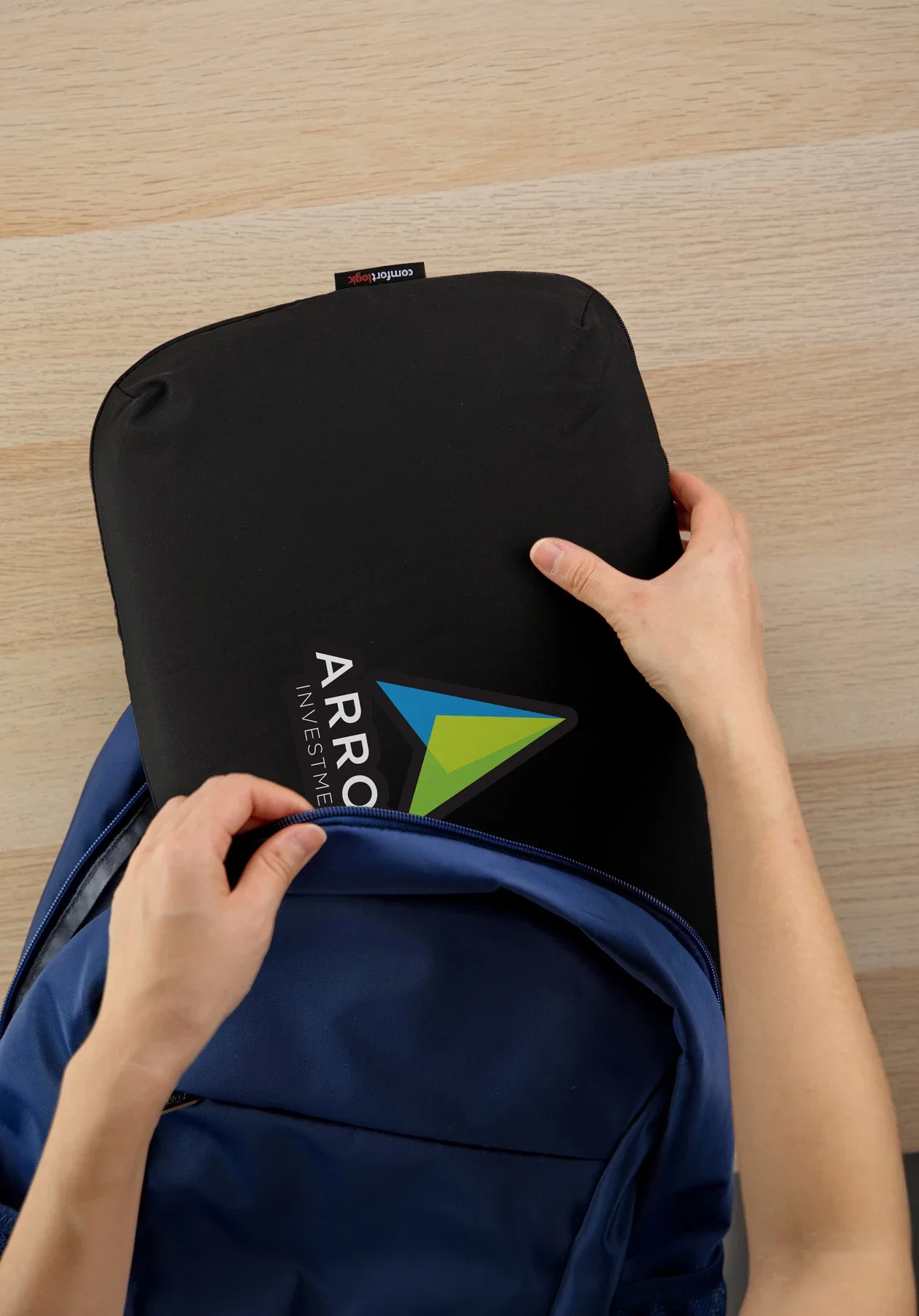 Branded Comfort Logic Everywhere Pillow in use during travel, lifestyle shot