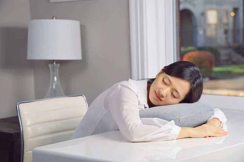 Promotional Comfort Logic pillow with its attachable carabiner clip, angled view
