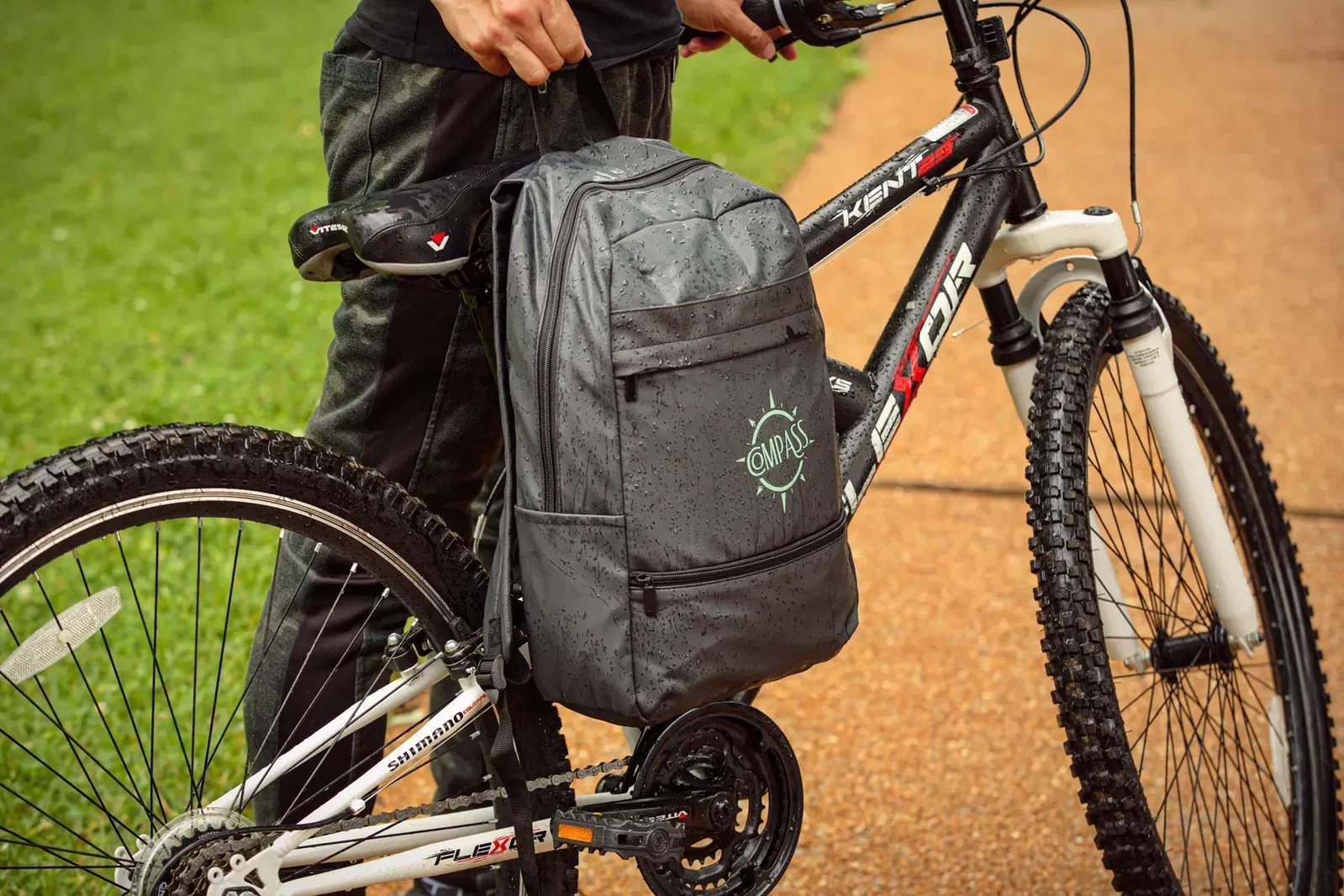 Custom branded Compass polyester backpack with padded straps, side angle view