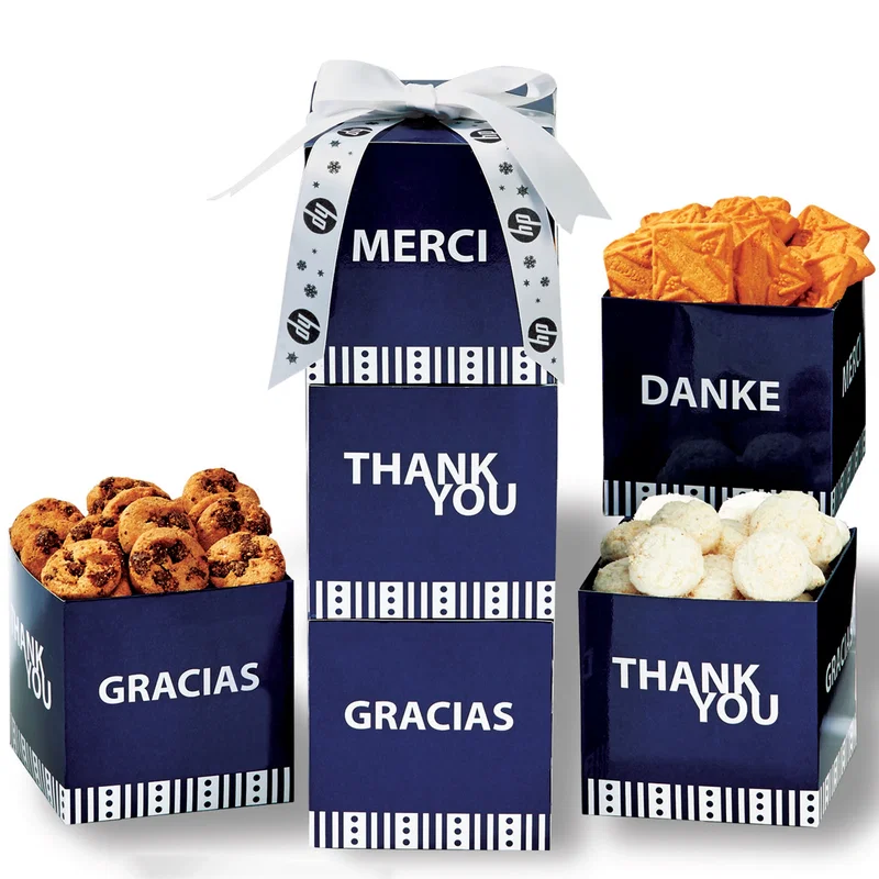 Three white boxes assembled into a tower of assorted cookies