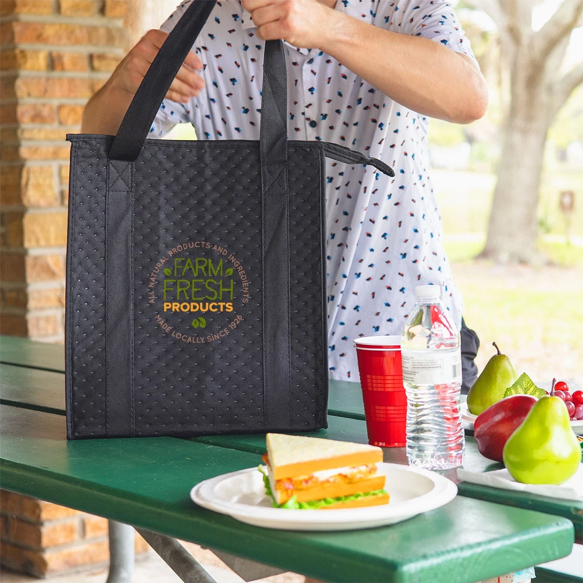 Dimples Non-Woven Cooler Tote Bag held in hand