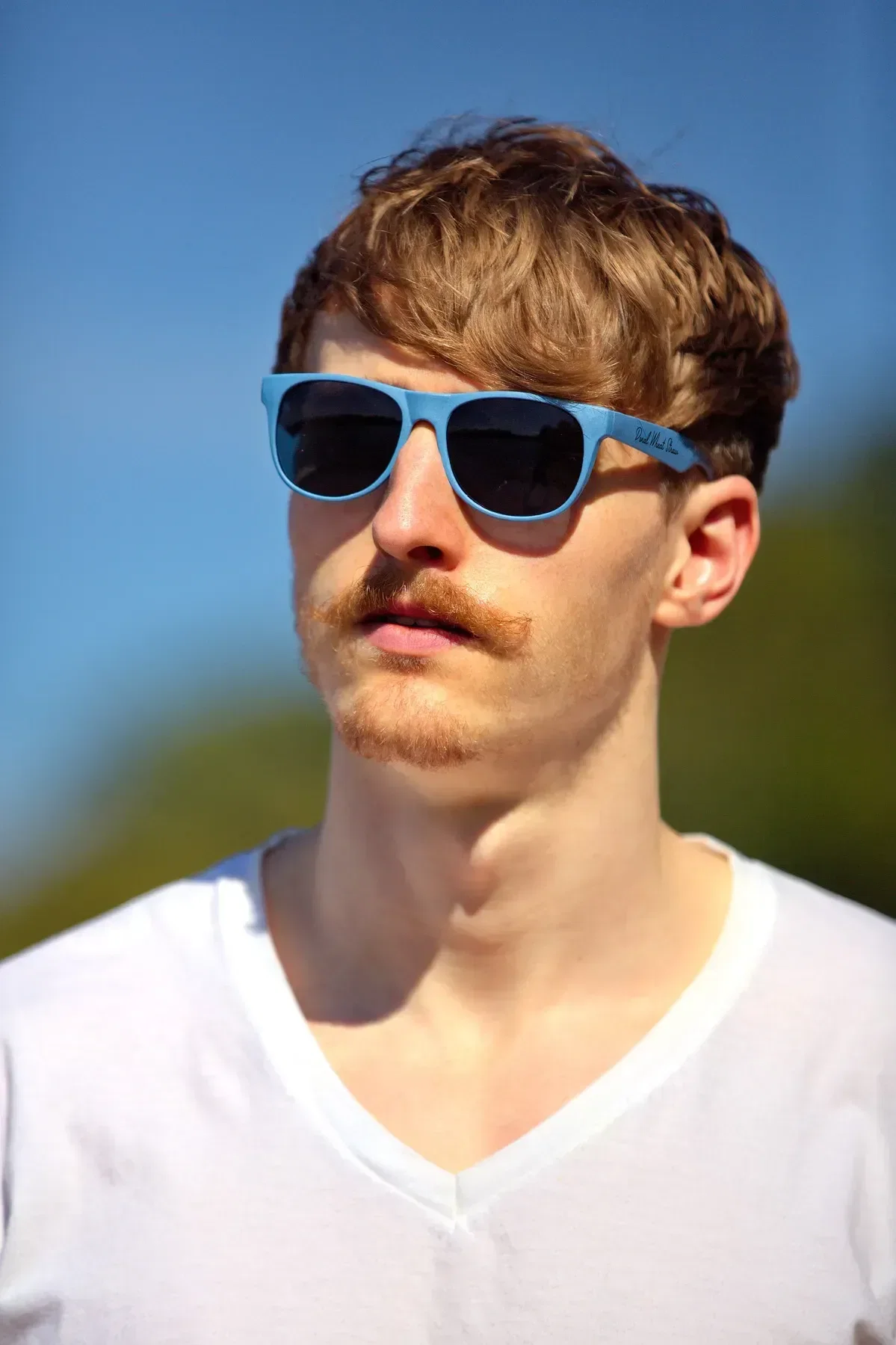 Doral custom wheat straw sunglasses side profile showing branded temple imprint area