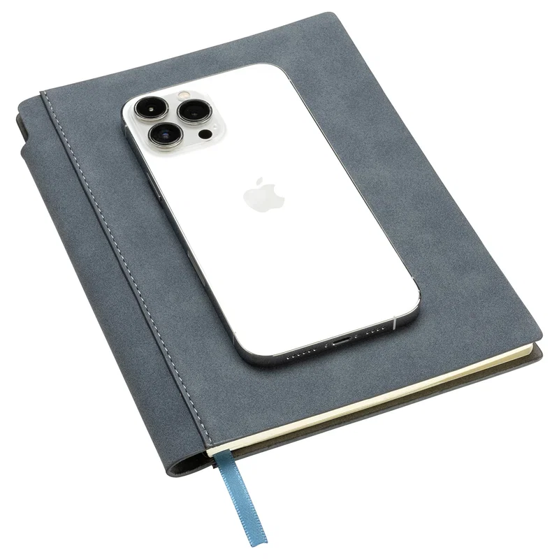 Closed Dossier Soft Cover Journal in gray shown next to a smartphone for size reference