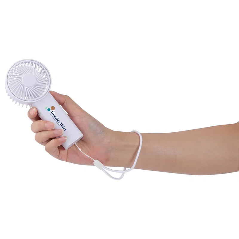 Easy Breeze hand fan held in hand with its wrist strap looped around the wrist