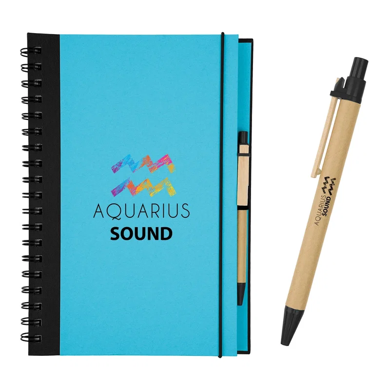 Hand holding the spiral notebook to show scale