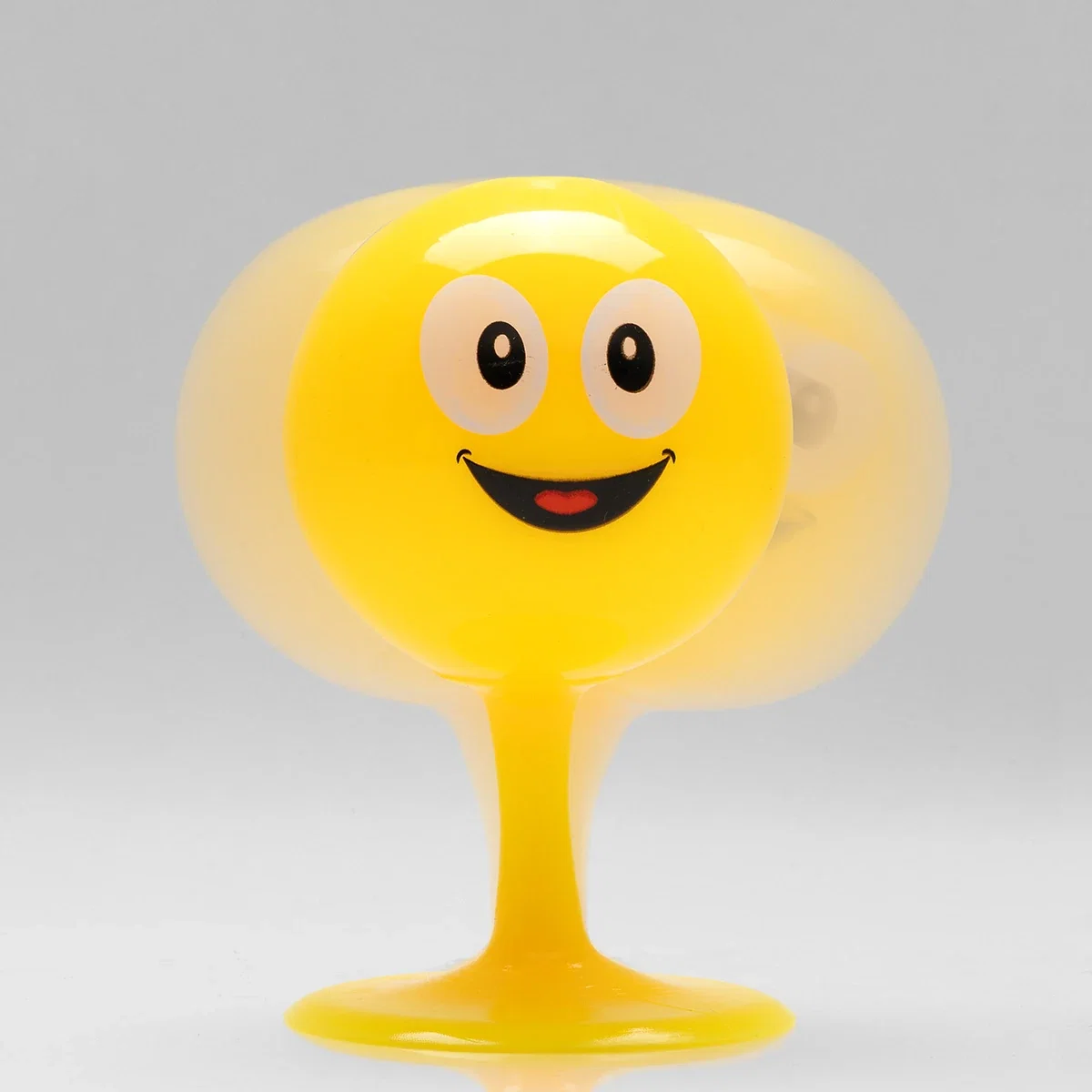 Close-up of the Emoji Bopper Desk Ball's wide-eyed smiley face design wobbling on its stem