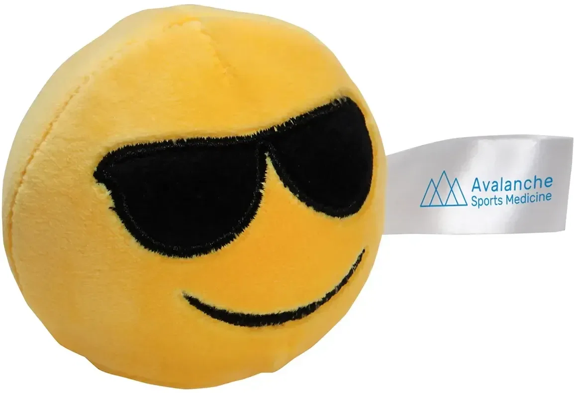 Branded emoji plush stress reliever, close-up of logo imprint area on the promotional squeeze toy