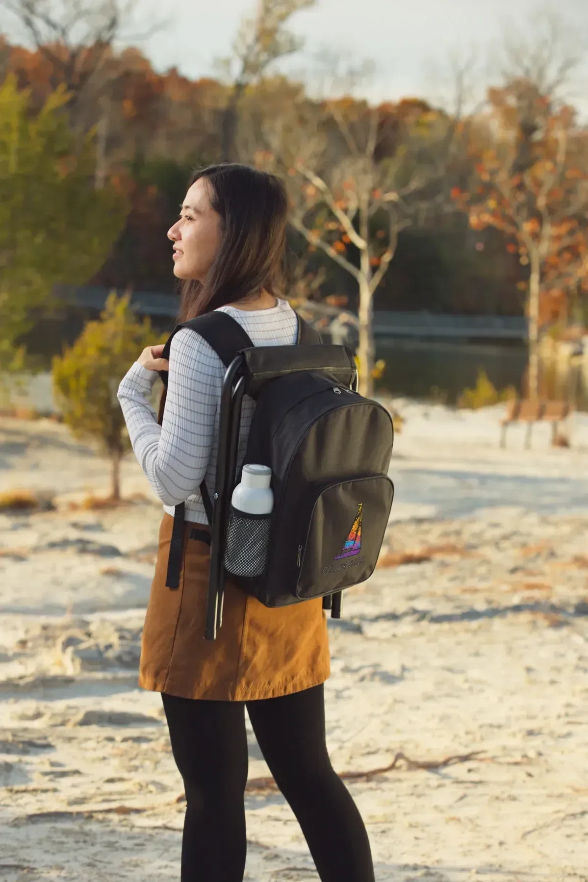Branded Fieldcrest cooler backpack unfolded into a folding stool seat