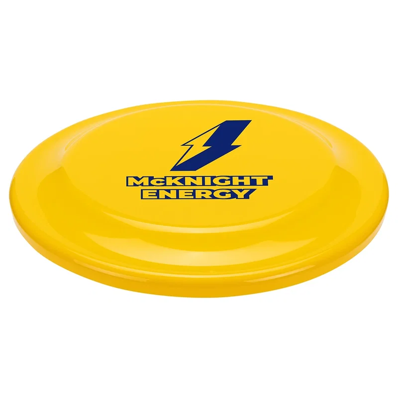 Angled view of the small Flick Flyer disc resting on a flat surface