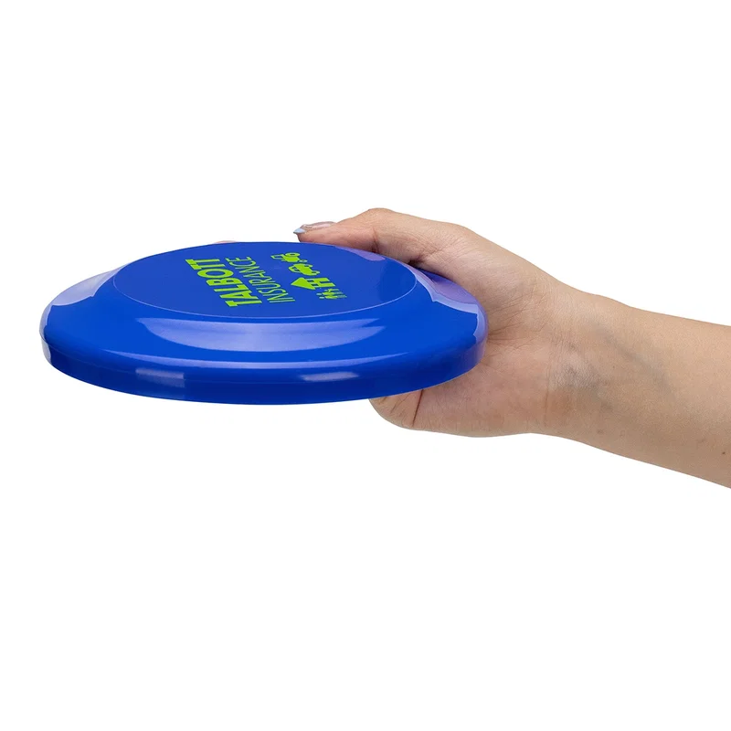 Angled view of the large Flick Flyer disc resting on a flat surface