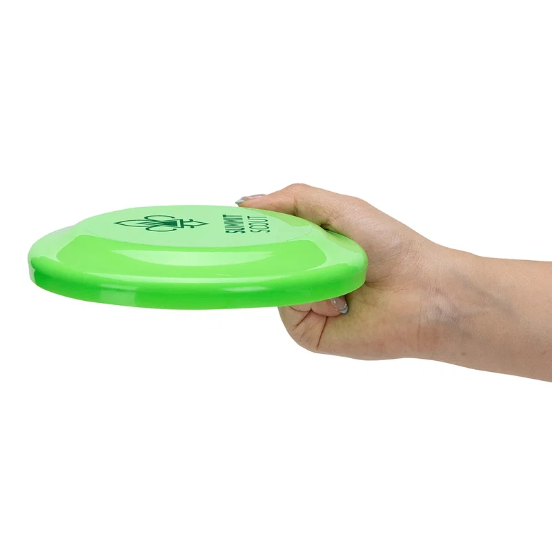 Flick Flyer disc held in hand to show its scale, promotional giveaway shot