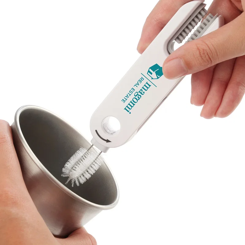 Gap 3-in-1 Cleaning Brush hanging from its handle hole on a rail near a sink