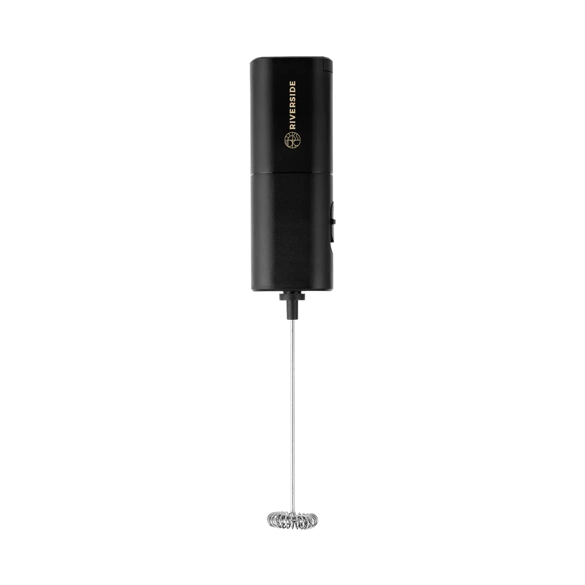 Angled view of the compact whisk beside a mug