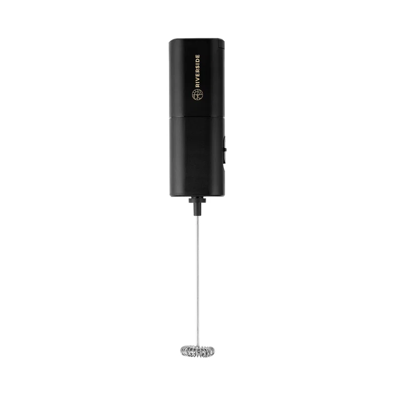 Angled view of the compact whisk beside a mug