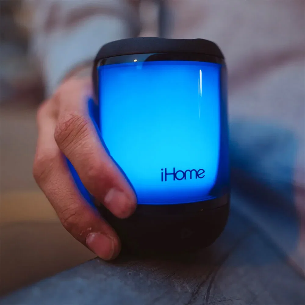 iHome PlayGlow Mini Waterproof Bluetooth Speaker with Color Changing Lights held in hand