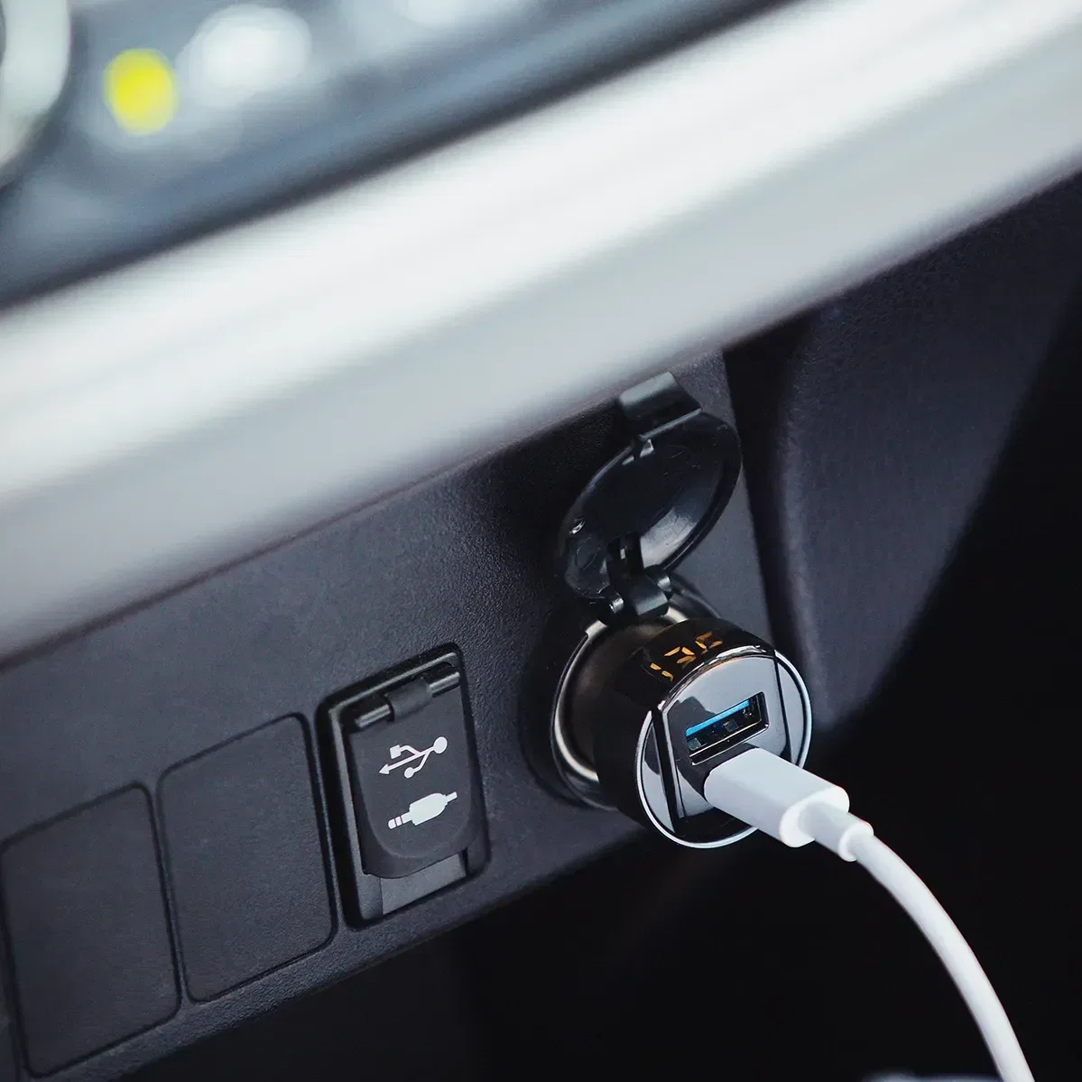 custom ihub PowerDrive charger in a car socket, branded dual-port car charger in use