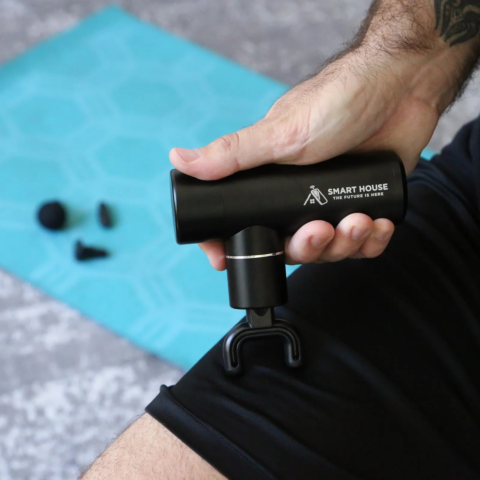 Kneado Handheld Massage Gun in use