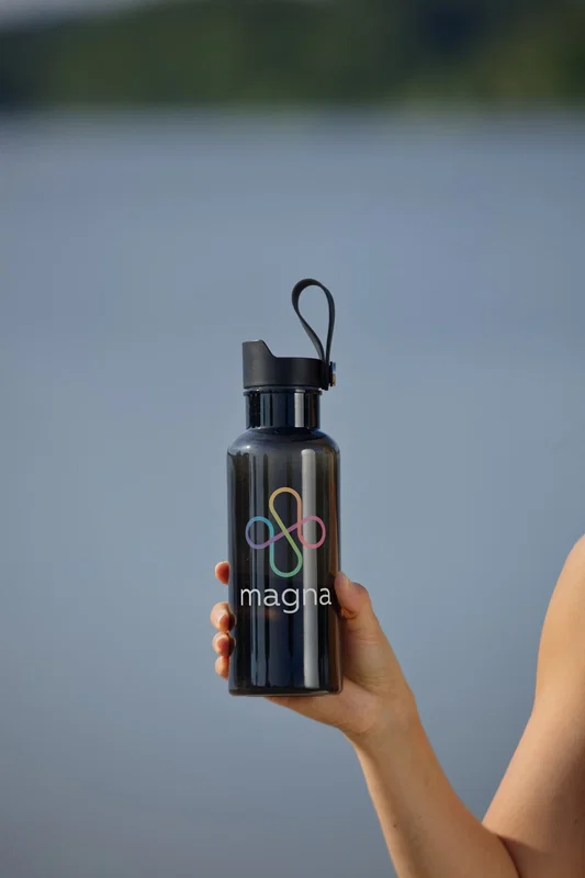 Group shot of the custom Lagoon 20 oz RPET Bottle staged with everyday accessories