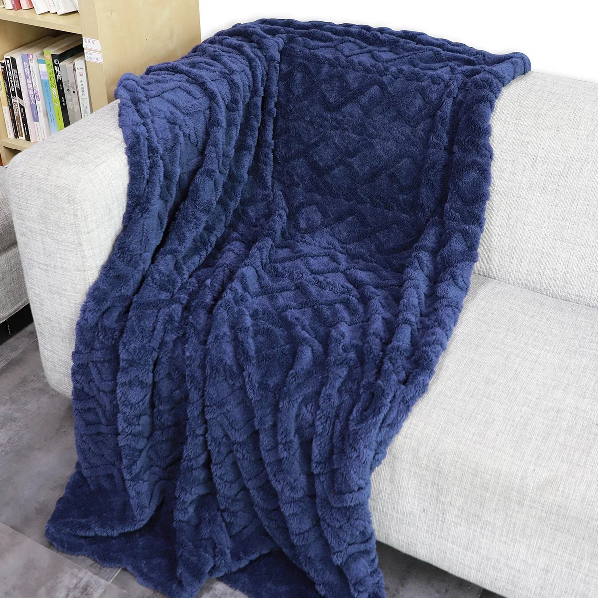 Legacy 280GSM RPET Sherpa Fleece Blanket draped over a couch, cozy lifestyle shot