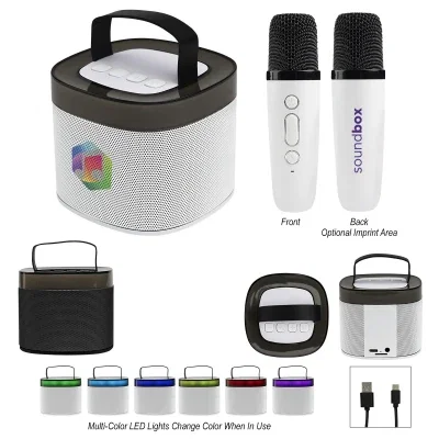 Microphone resting beside the cube shaped white speaker