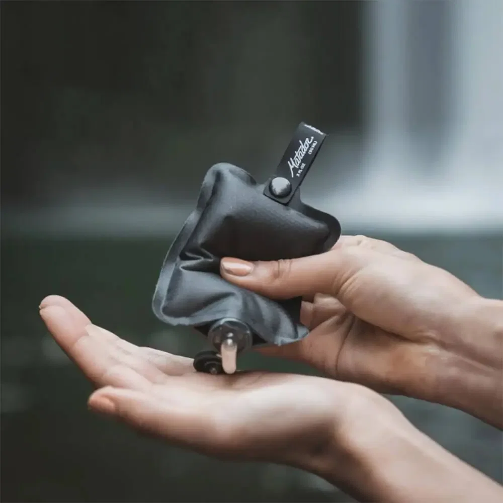 Matador FlatPak™ Toiletry Bottle held in hand
