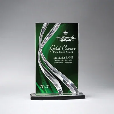 Small acrylic award standing upright on a plain surface