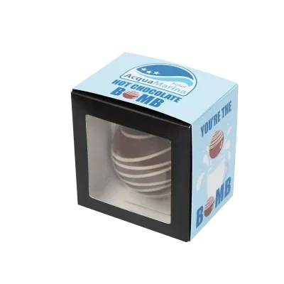 Milk chocolate beverage bomb shown with its white box