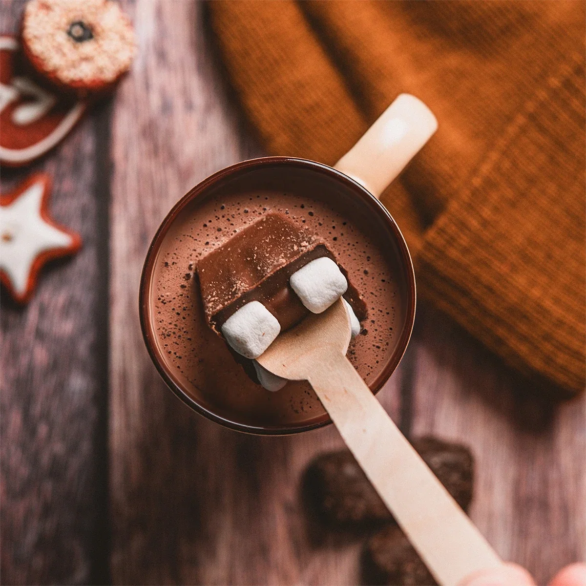 Milk Chocolate Beverage Spoon held in hand