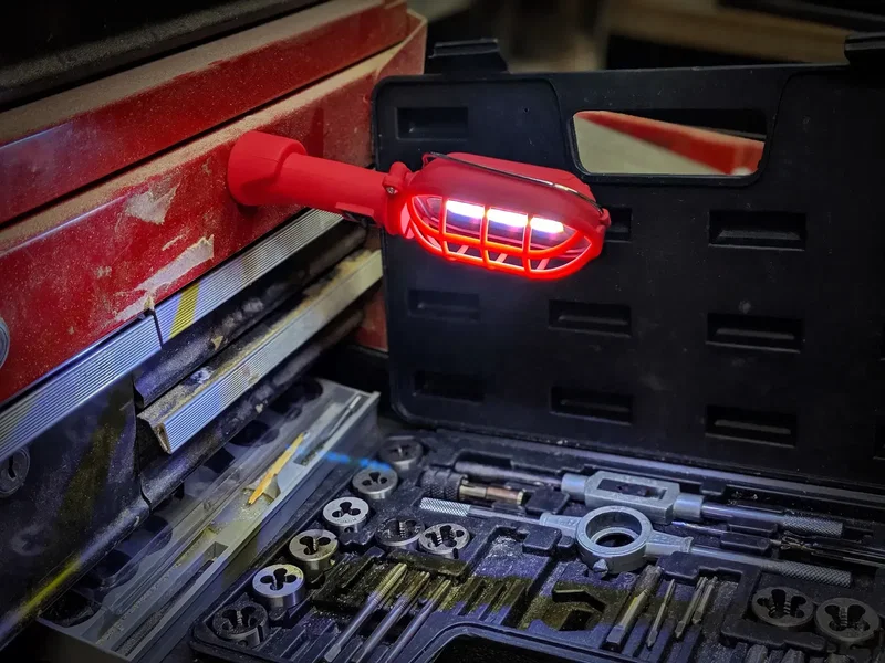 Promotional COB work light shown lighting a garage workbench