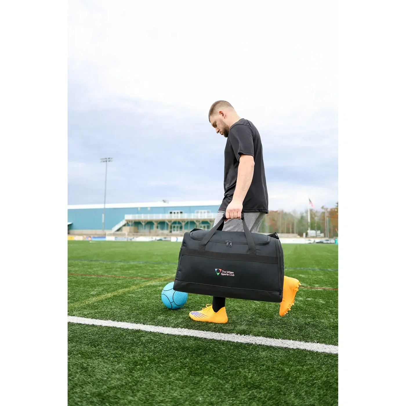 New Balance® Team Duffel Bag - Medium held in hand