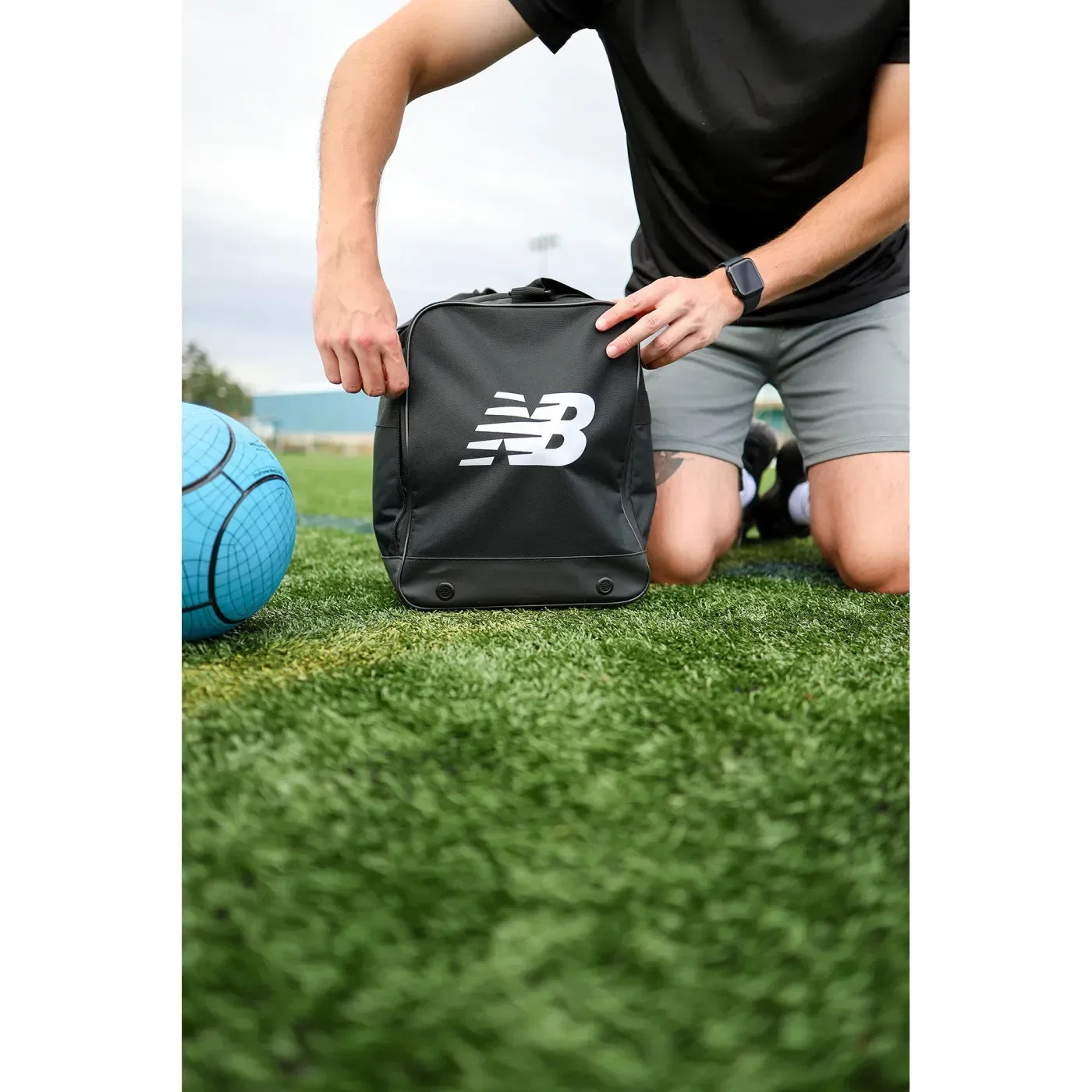 New Balance® Team Duffel Bag - Small held in hand